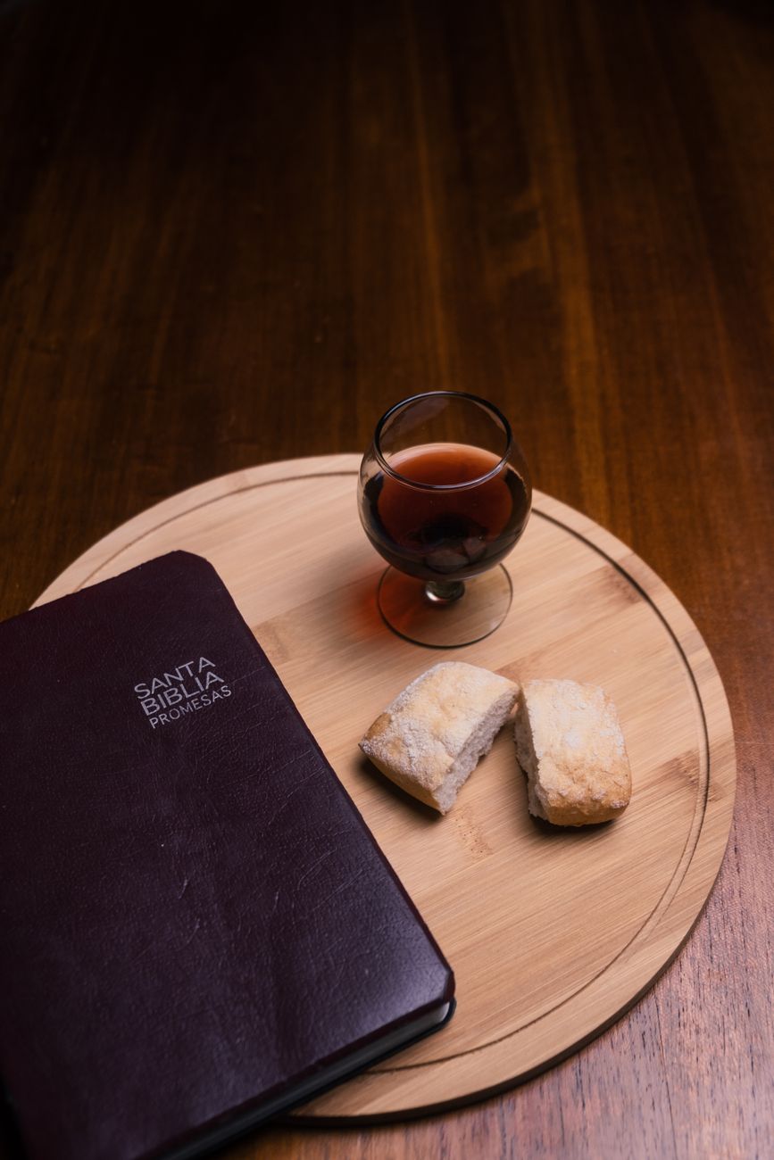 glass of wine beside a bible
